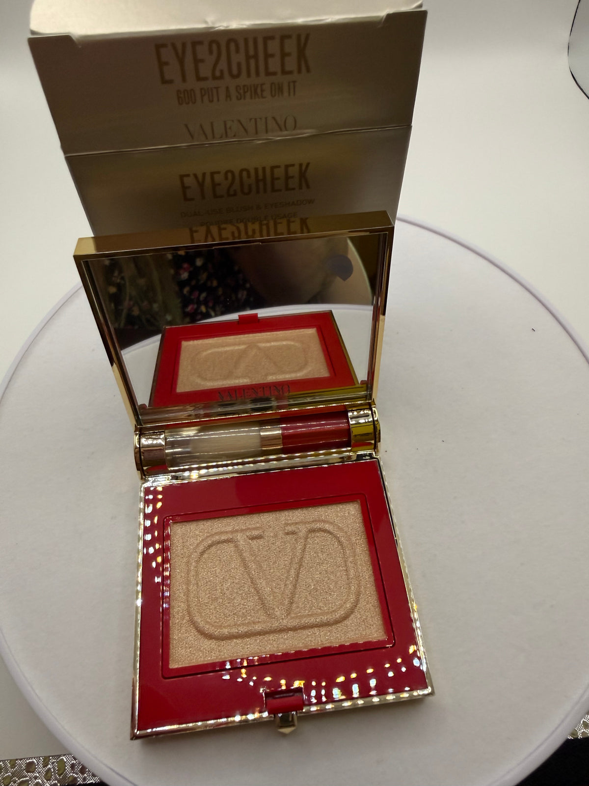 Open Valentino Eye2Cheek compact showing gold-toned powder and mirror